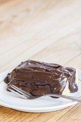 Chocolate cream on the cake with fork