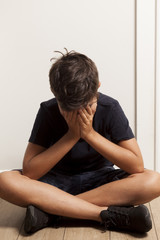 sadness child hands on face