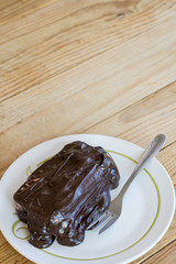 Chocolate cream on the cake with fork
