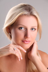 Beautiful young blonde shows off jewelry ring with stone