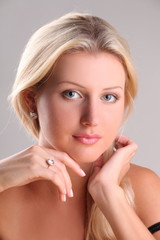 Beautiful young blonde shows off jewelry ring with stone