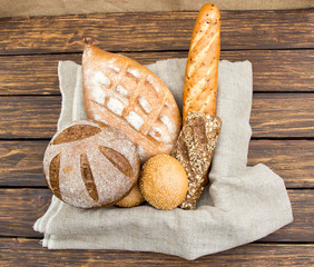 Different bread in  basket on wooden  table