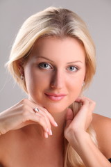 Beautiful young blonde shows off jewelry ring with stone