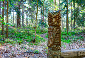 Old wooden sculptures in the forest. Witch Hill park, Lithuania.