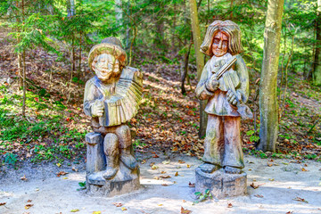 Old wooden sculptures in the forest. Witch Hill park, Lithuania.