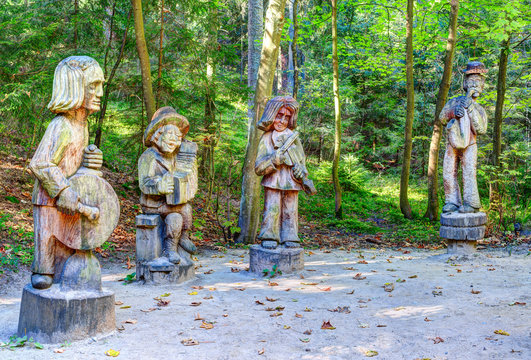 Old wooden sculptures in the forest. Witch Hill park, Lithuania.