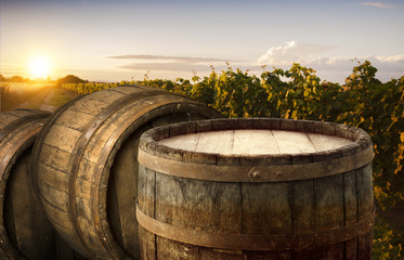 Red wine with barrel on vineyard in green Tuscany, Italy