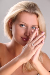 Beautiful young blonde shows off jewelry ring with stone