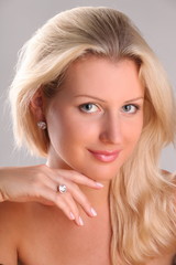 Beautiful young blonde shows off jewelry ring with stone