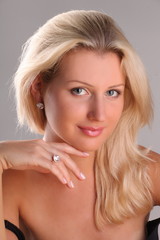 Beautiful young blonde shows off jewelry ring with stone