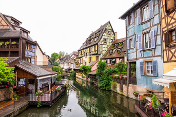 Fototapeta na wymiar Canal and colorful houses in Petite Venice, Colmar, France. View from bridge in cloudy day.