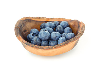 Fresh blueberries in a rustic wooden bowl