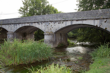A Stone Bridge Over A River In Autumn