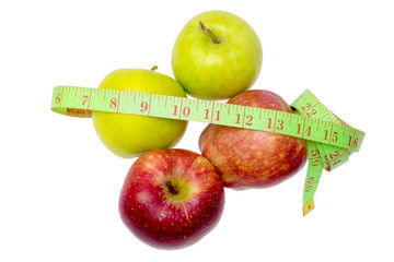 Two green apples, two read apples and measuring tape isolated on white.