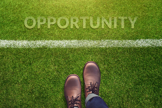 Opportunity Concept, Male with Leather Shoes Standing and steps behind a line on Green Grass Field with word: Opportunity, Top view