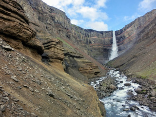 Hengifoss waterfall in Iceland with red rock striations 