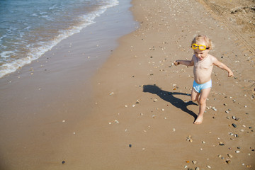 Cute little girl playing on the beach
