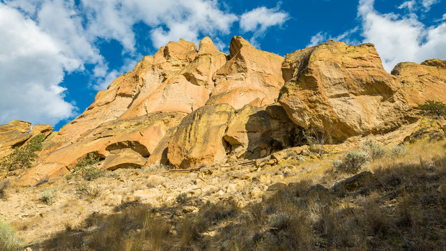 Unusual shaped rocks on the background of blue sky. Beautiful landscape of yellow sharp cliffs. Smith Rock state park, Oregon