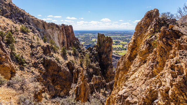 Beautiful rocks in the foreground. Colorful valley between the mountains. Beautiful landscape of yellow sharp cliffs. Smith Rock state park, Oregon