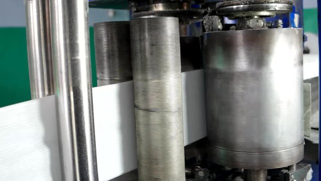 shaft of the embossing pattern on napkins. huge rolls of paper recycled. recycled use in the manufacture of paper napkins and paper towels, large roll mounted on the machine for the production.