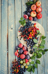 Decorative fruits and berries on a wooden background. 