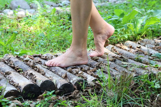 woman walking barefoot in the wood