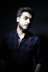 Fototapeta premium Boy in darkness isolated inside Studio