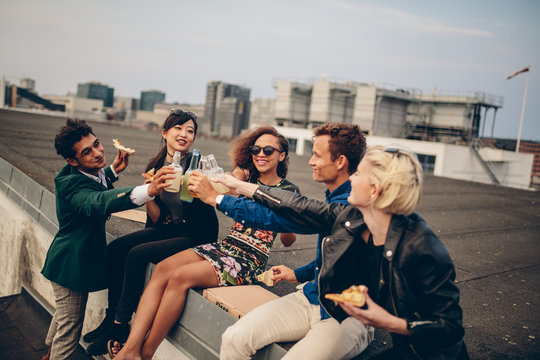 Diverse group of young friends on terrace party