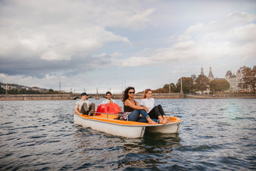 Group of people on pedal boat in lake