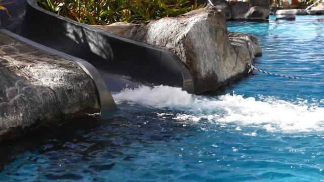 A water slide into the pool.