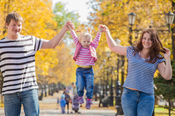 Fototapeta premium happy family in the same clothes for a walk in the park in autumn