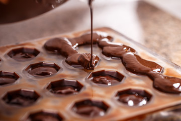 Pouring chocolate in mold © Grafvision
