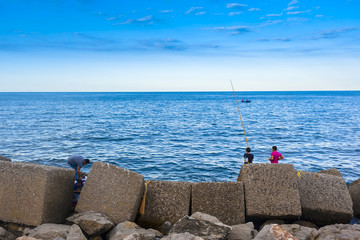 amateur fishermen who fish from the dock in a port