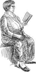 elderly woman reads a book