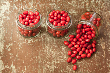 Ripe cornelian cherry in glass jars