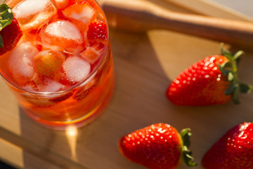Fresh made Strawberry Caipirinha on wooden background