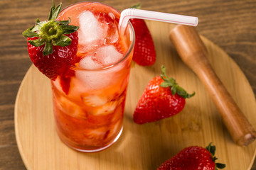 Fresh made Strawberry Caipirinha on wooden background