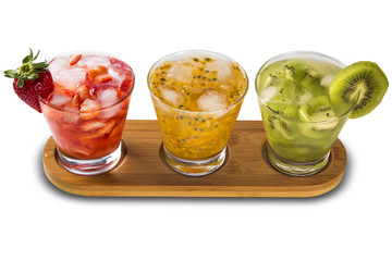 Three drinks made with passion fruit, strawberry and kiwi Caipir
