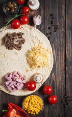 Cooking tortilla wraps with ham, corn, cheese, mushrooms and carrot