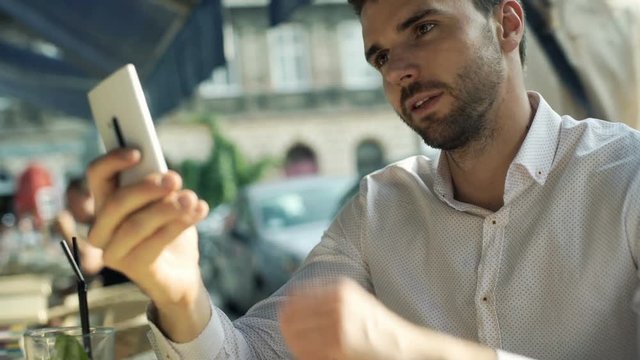 Man looking absorbed while browsing internet on smartphone
