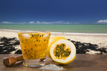 Fresh drink made with passion fruit Caipirinha in the beach back