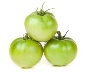 Three green unripe tomato isolated on white background
