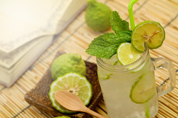 Kaffir lime, Bergamot soda Cool drink, Herb for Treatment of Acid Reflux, with Earth tone background
