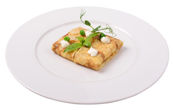 Pancake with sauce and green peas, isolated