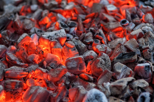 Glowing hot red embers for cooking barbecue close-up texture background