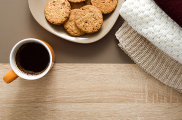 Coffee and biscuits with warm clothes indoors on autumn