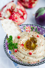 Arabic food baba ghanoush close-up on the plate and ingredients  the table. vertical