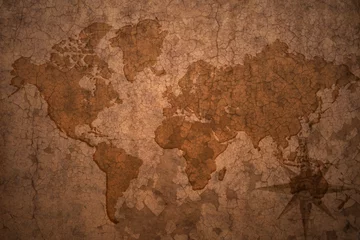 Wall murals Old dirty textured wall world map on a old vintage crack paper background