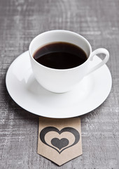 Coffee cup hot white on wooden board with heart label