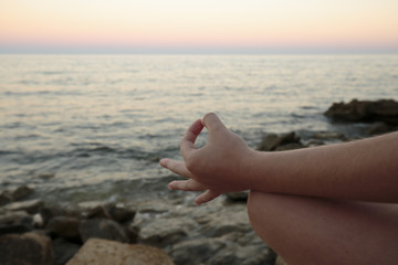 Girl meditating on a beach